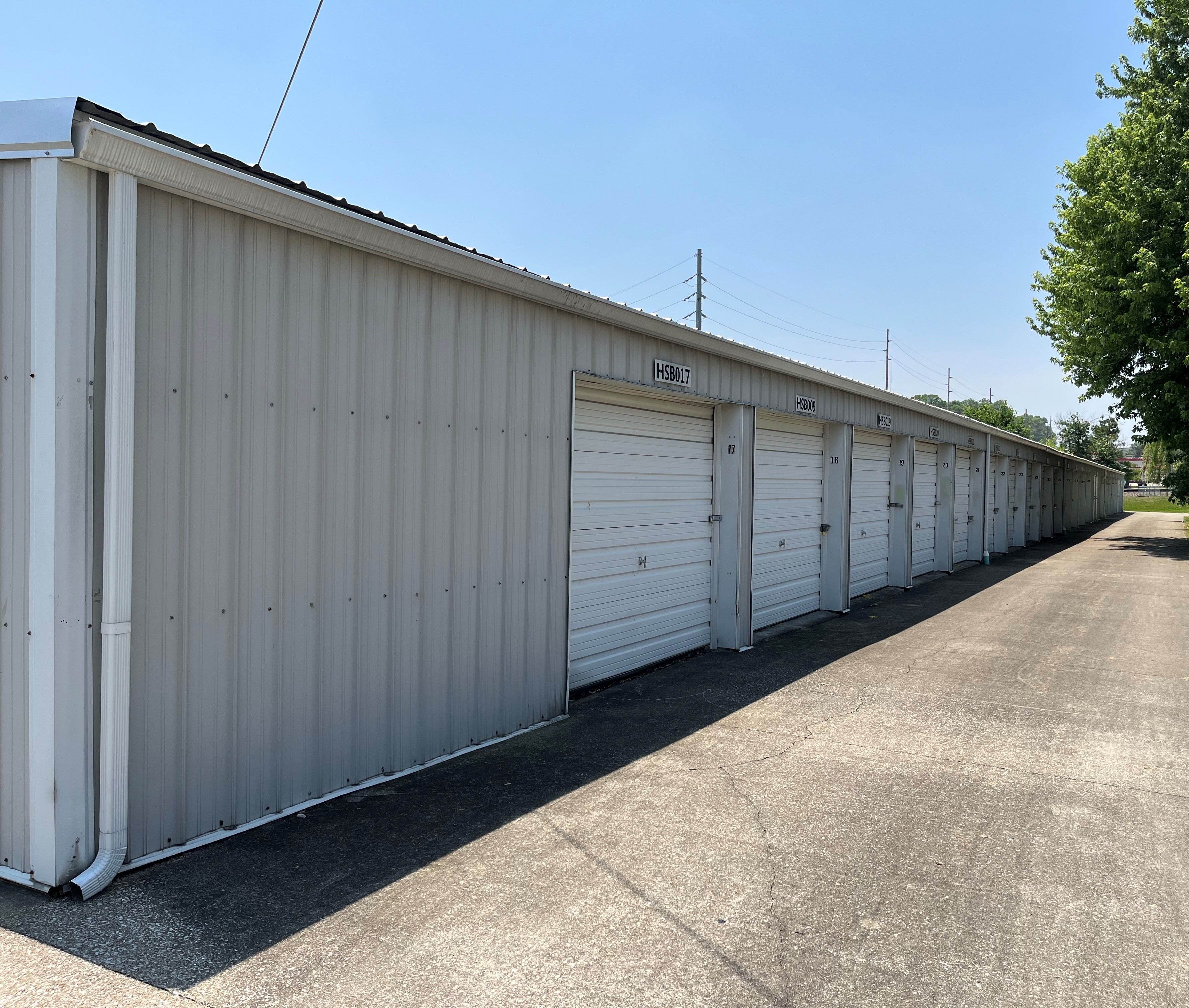 Safe and convenient drive-up storage in Huntingburg, featuring white doors and well-paved access driveways.